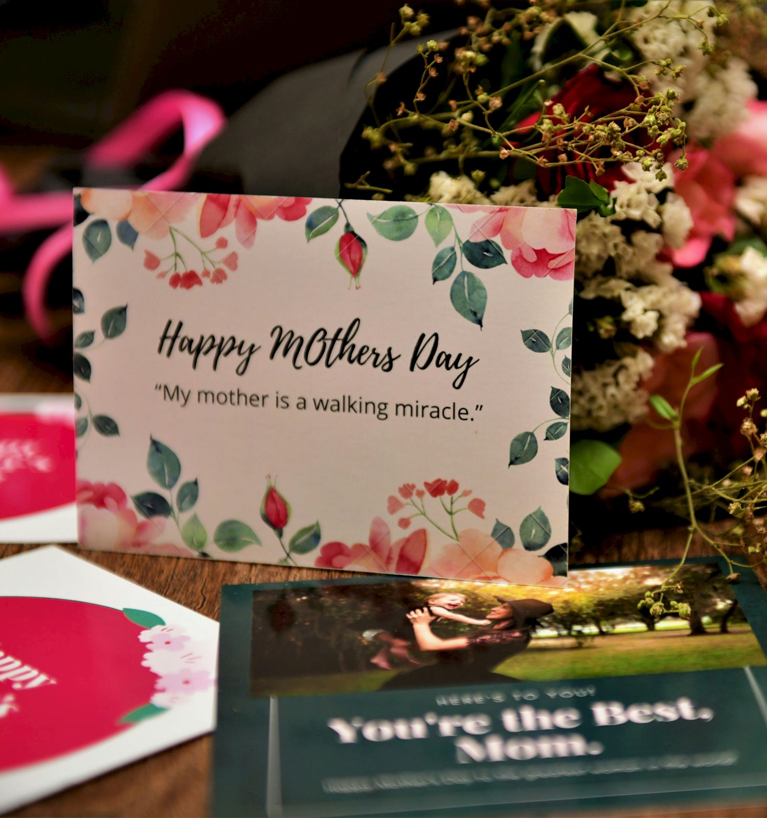 A Mother&rsquo;s Day display with a floral card reading &ldquo;Happy Mother&rsquo;s Day,&rdquo; surrounded by bouquets, gift tags, and a glowing, heartfelt message card.